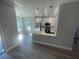 Stylish kitchen open to the living area, featuring white cabinets and stainless steel appliances at 8204 Chimney Rock Dr, Webster, FL 33597
