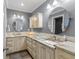 Bathroom featuring dual sinks, round mirrors, granite countertops and decorative vanity lighting at 827 Timber Pond Dr, Brandon, FL 33510