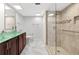 Elegant bathroom with a glass bowl sink, wood vanity, tiled shower, and modern fixtures at 851 Bayway Blvd # 904, Clearwater Beach, FL 33767