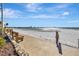 Scenic beach view with benches, featuring soft sand and distant skyline, perfect for relaxation at 851 Bayway Blvd # 904, Clearwater Beach, FL 33767