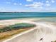 A gorgeous beach view with an American flag waving in the foreground at 851 Bayway Blvd # 904, Clearwater Beach, FL 33767