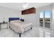 Light-filled bedroom with a sliding glass door leading to a balcony, complete with marble floors at 851 Bayway Blvd # 904, Clearwater Beach, FL 33767