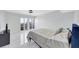 Serene bedroom featuring marble floors, a comfortable bed, and sliding glass doors leading to a balcony at 851 Bayway Blvd # 904, Clearwater Beach, FL 33767
