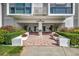 Inviting entrance to 851 Yacht House, featuring lush greenery, decorative planters, and a clean, modern facade at 851 Bayway Blvd # 904, Clearwater Beach, FL 33767