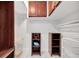 Walk-in closet with marble floors, built-in storage cabinets, shelves, and hanging racks at 851 Bayway Blvd # 904, Clearwater Beach, FL 33767