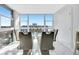 Elegant dining room with a glass table, modern chairs, and large windows offering a scenic view at 851 Bayway Blvd # 904, Clearwater Beach, FL 33767