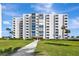 Beautiful condo building with a manicured lawn and landscaping, offering a serene residential setting at 851 Bayway Blvd # 904, Clearwater Beach, FL 33767