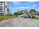 Exterior view of well-maintained condo buildings surrounded by lush landscaping and palm trees at 851 Bayway Blvd # 904, Clearwater Beach, FL 33767