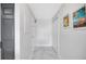 Bright hallway with marble floors, closet, and decor at 851 Bayway Blvd # 904, Clearwater Beach, FL 33767
