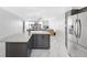 Open concept kitchen with gray cabinets, stainless steel appliances, white countertops, and marble floors at 851 Bayway Blvd # 904, Clearwater Beach, FL 33767