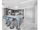 Modern kitchen with stainless steel appliances, island with seating, and sleek gray cabinetry at 851 Bayway Blvd # 904, Clearwater Beach, FL 33767