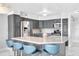 Stylish kitchen with gray cabinets, granite countertops, stainless steel appliances, and a large center island at 851 Bayway Blvd # 904, Clearwater Beach, FL 33767