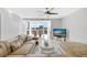 Bright living room with a ceiling fan, large window, modern furniture, and a television for a comfortable and stylish space at 851 Bayway Blvd # 904, Clearwater Beach, FL 33767