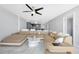 Open-concept living room with marble floors, modern furniture, an updated kitchen, and ample natural light at 851 Bayway Blvd # 904, Clearwater Beach, FL 33767