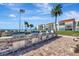 Outdoor grilling area with multiple stainless steel grills set against a backdrop of palm trees and waterfront views at 851 Bayway Blvd # 904, Clearwater Beach, FL 33767