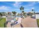 Outdoor pool area surrounded by lounge chairs, palm trees and beautiful landscaping at 851 Bayway Blvd # 904, Clearwater Beach, FL 33767