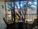 Balcony with chairs and furniture overlooking mature trees and condos at 861 Maple Ct # 307, Dunedin, FL 34698