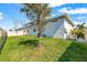 A well-manicured backyard with a mature shade tree at 8721 Drummer Plank Dr, Wesley Chapel, FL 33545
