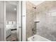 This bathroom features a gray-tiled shower and an adjacent bedroom with natural light at 8721 Drummer Plank Dr, Wesley Chapel, FL 33545