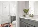 Bright bathroom featuring gray cabinetry, a white countertop, and a neutral-toned floor at 8721 Drummer Plank Dr, Wesley Chapel, FL 33545