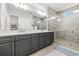 Stylish bathroom featuring a glass shower, dual sinks, and modern finishes creating a spa-like experience at 8721 Drummer Plank Dr, Wesley Chapel, FL 33545