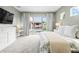 This spacious bedroom offers a neutral color palette and private pool views at 8721 Drummer Plank Dr, Wesley Chapel, FL 33545