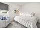 Cozy bedroom with a patterned bedspread, reading chair, and a window offering natural light at 8721 Drummer Plank Dr, Wesley Chapel, FL 33545