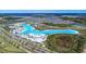 Aerial view of large community lagoon with white sand beaches and recreation areas at 8721 Drummer Plank Dr, Wesley Chapel, FL 33545