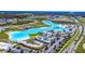 Aerial view of large community lagoon with white sand beaches, docks, and recreation areas at 8721 Drummer Plank Dr, Wesley Chapel, FL 33545