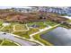 Aerial view of community park featuring a playground, picnic area, and pond at 8721 Drummer Plank Dr, Wesley Chapel, FL 33545