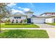 Attractive home showcasing a three-car garage, well-maintained landscaping, and a welcoming front entrance at 8721 Drummer Plank Dr, Wesley Chapel, FL 33545