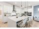 Bright kitchen with a large center island, pendant lighting, stainless steel appliances, and white cabinetry at 8721 Drummer Plank Dr, Wesley Chapel, FL 33545