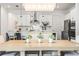 Bright dining area showcasing a modern kitchen with stainless steel appliances and elegant lighting at 8721 Drummer Plank Dr, Wesley Chapel, FL 33545