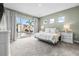 Serene bedroom featuring carpet floors, natural light, and private access to the outdoor pool area at 8721 Drummer Plank Dr, Wesley Chapel, FL 33545