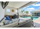 Inviting outdoor space features a beautiful pool and comfortable seating under a covered patio area at 8721 Drummer Plank Dr, Wesley Chapel, FL 33545