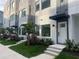 Modern townhome featuring clean lines, manicured landscaping, and private entrances at 879 6Th S Ave, St Petersburg, FL 33701