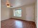 Inviting living room featuring a ceiling fan, spacious layout, and a large window for natural light at 9009 Pebble Creek Dr, Tampa, FL 33647