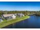 Aerial view of lakefront homes with screened pools and lush green lawns at 9108 Woodbay Dr, Tampa, FL 33626