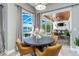 Dining area with views of screened lanai, pool and waterfront, adjacent to the outdoor living space at 9108 Woodbay Dr, Tampa, FL 33626