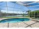 Screened-in pool and spa with lake views, creating a serene and private outdoor oasis at 9108 Woodbay Dr, Tampa, FL 33626