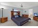 Spacious bedroom featuring light blue walls, wooden furniture, and a ceiling fan at 9212 111Th St, Seminole, FL 33772