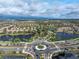 Aerial view of a Primary-planned community with a modern roundabout near ponds and manicured landscaping at 10446 Highland Park Pl, Palmetto, FL 34221