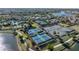 The community has tennis courts, pickleball courts, and lake access with tropical landscaping and walking paths at 10446 Highland Park Pl, Palmetto, FL 34221