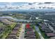 Aerial view of a neighborhood with lakes, lush landscaping, and tile roofs at 10446 Highland Park Pl, Palmetto, FL 34221