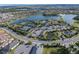 Aerial view of community amenities like a pool, clubhouse, ponds, and tennis and pickleball courts at 10446 Highland Park Pl, Palmetto, FL 34221