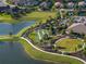 Beautiful aerial view of outdoor amenities like bocce ball, a fire pit, and ponds at 10446 Highland Park Pl, Palmetto, FL 34221
