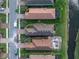 Aerial view of homes featuring a pool and manicured lawns at 10446 Highland Park Pl, Palmetto, FL 34221