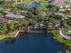 Aerial view of a beautifully landscaped community with a picturesque water feature and lush green spaces at 10446 Highland Park Pl, Palmetto, FL 34221