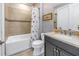 Bathroom with single sink vanity, granite countertop, and patterned shower curtain at 10446 Highland Park Pl, Palmetto, FL 34221