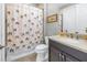 Bathroom with single sink vanity, granite countertop, and patterned shower curtain at 10446 Highland Park Pl, Palmetto, FL 34221